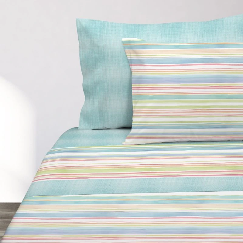 Sábanas de rayas multicolores Manterol con la almohada azul - Algodonea